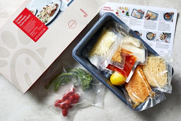 Öppnad matkasse med vakuumförpackade ingredienser för Chicken Parmesan.